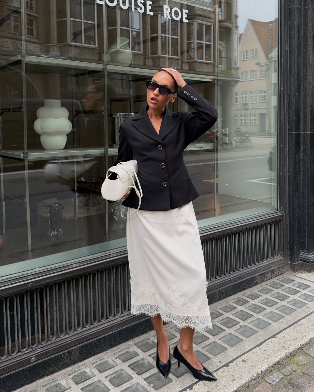 Ingrid in black blazer and white skirt