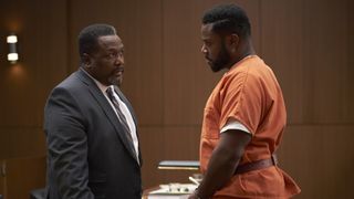 Wendell Pierce and Malcolm-Jamal Warner standing inside of a courtroom in Accused