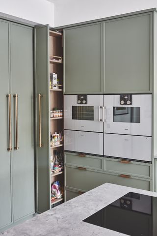 Green kitchen with pull out pantry drawer