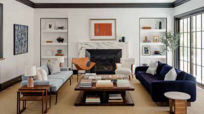 living room with white walls, black window frames, skirtings and moldings, and mid-century furniture