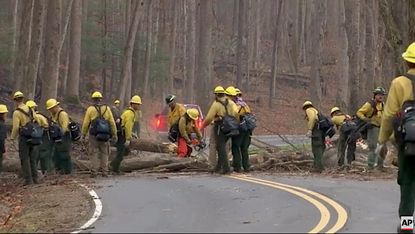 Firefighters clear a road in Great Smokey Mountains National Park