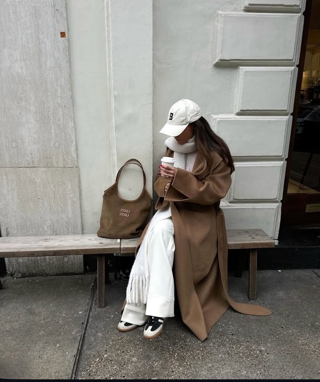 @felicitymbird wears white trousers and brown coat