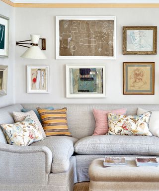 gallery wall in a living room with a corner couch
