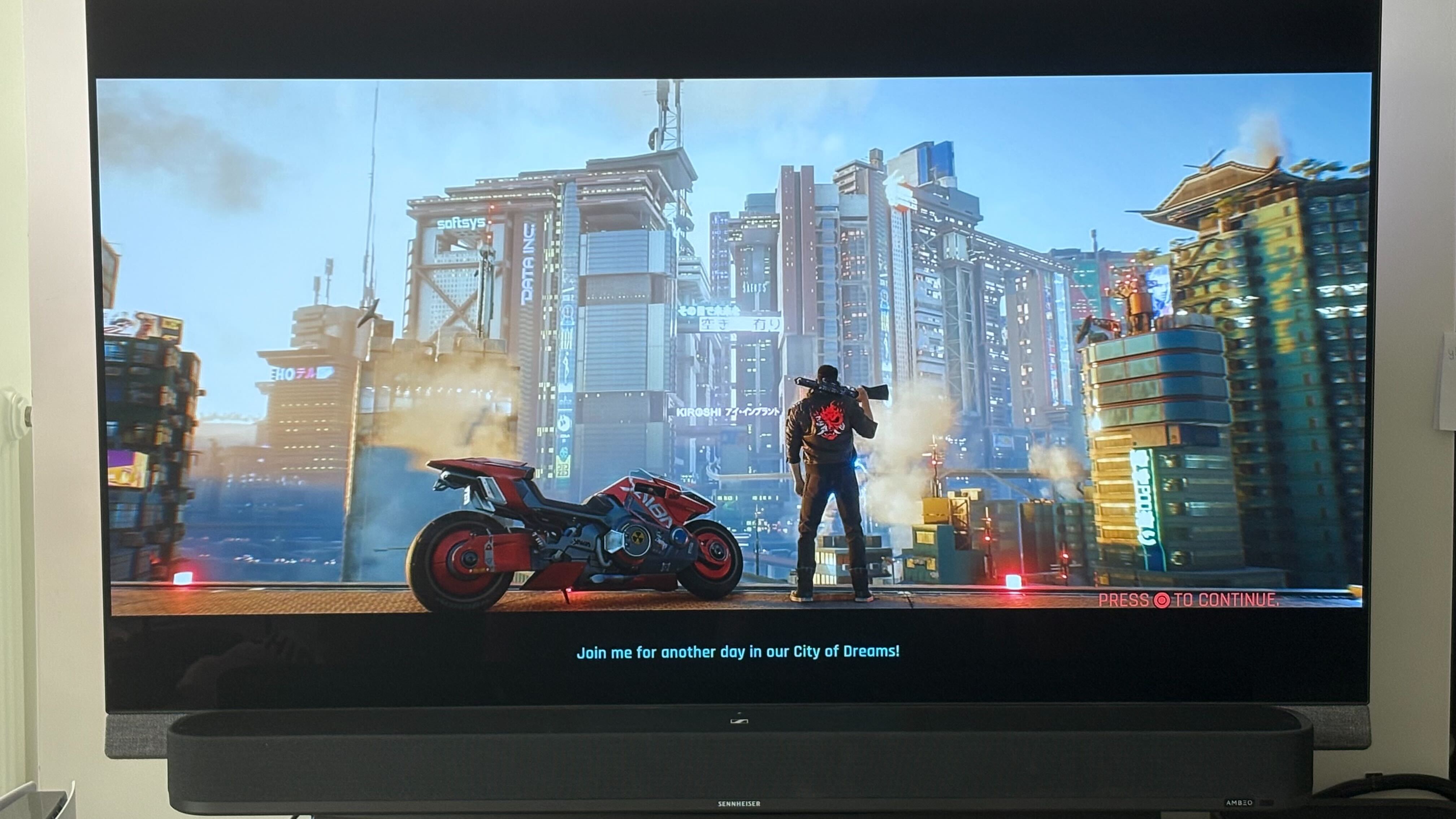 A TV and soundbar with Cyberpunk 2077 on screen