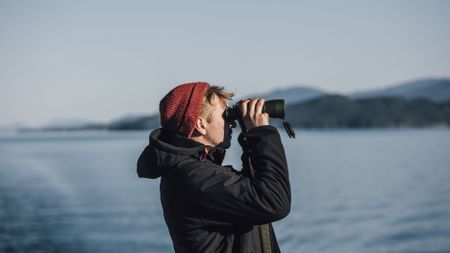 Binoculars for sale: Image shows man holding the best solar binoculars to face