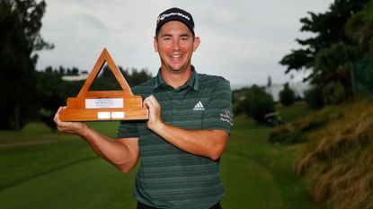 New Zealander Lucas Herbert poses with the trophy after winning the 2021 Butterfield Bermuda Championship
