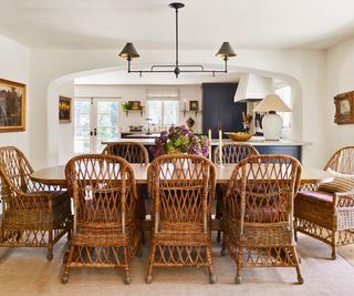 dining space with basket chairs and arch to kitchen