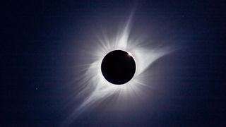 A composite of the August 21, 2017 total solar eclipse showing third contact – the end of totality – with sunlight beginning to reappear and the array of pink prominences along the limb of the Sun Seconds later the emerging Sun and diamond ring overwhelmed the large prominence Regulus is at lower left This is a composite of two images taken seconds apart: a 1/15th second exposure for the corona and a 1/1000 sec exposure for the prominences and chromosphere Taken with the 106mm Astro-Physics apo refractor at f/5 and Canon 6D MkII camera at ISO 100 On the Mach One equatorial mount, polar aligned and tracking the sky. (