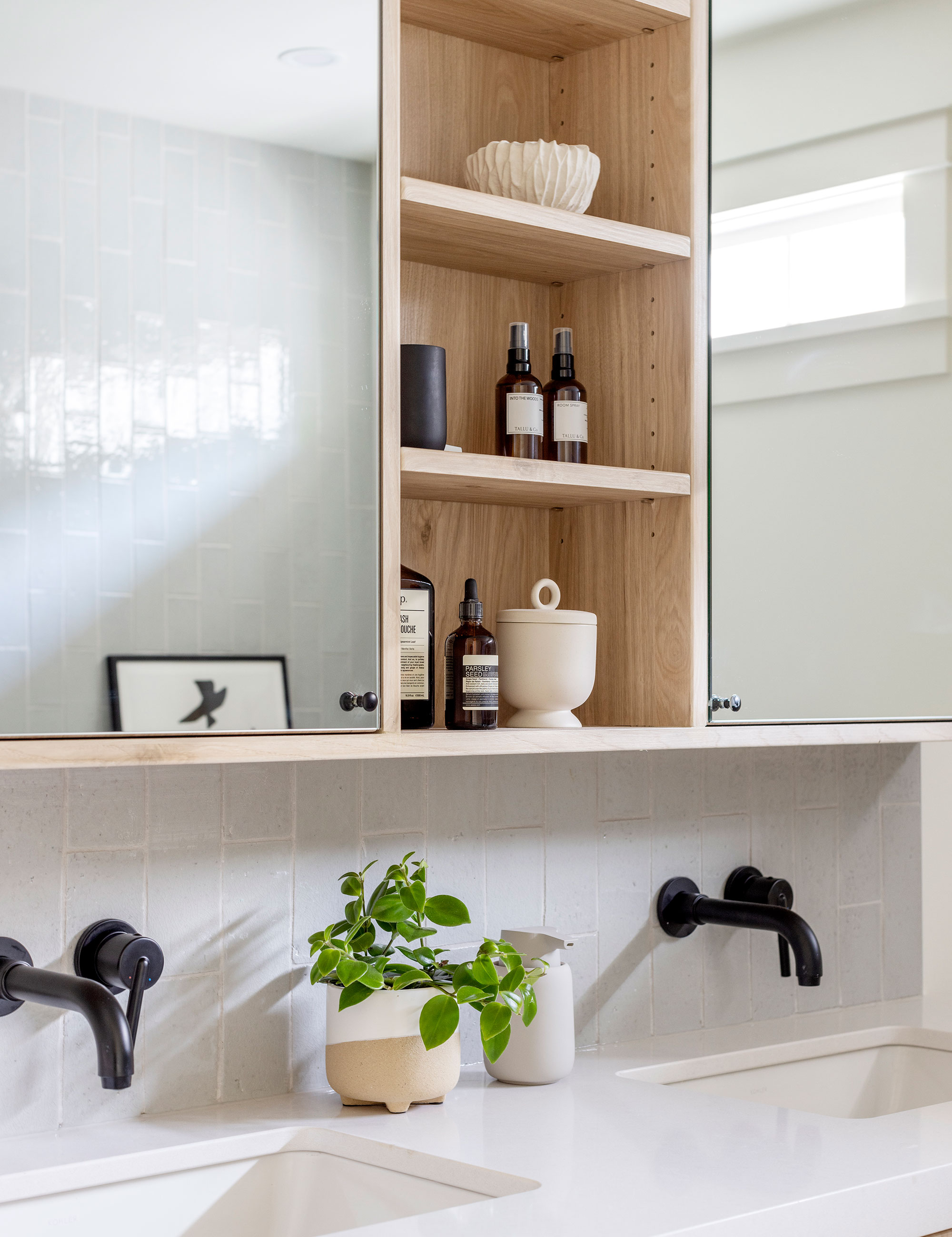 Neutral bathroom with wooden glass-fronted medicine cabinet