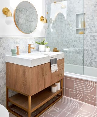 Small bathroom with sculptural design floor tiles continuing onto bathtub