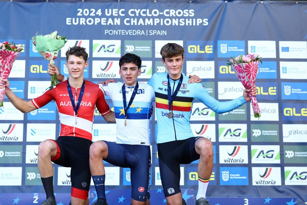 Austrian Valentin Hofer, Italian Mattia Agostinacchio and Belgian Mats Vanden Eynde celebrate on the podium after the men junior race at the European Championships cyclocross cycling in Pontevedra, Spain, Sunday 03 November 2024. BELGA PHOTO DAVID PINTENS (Photo by DAVID PINTENS / BELGA MAG / Belga via AFP) (Photo by DAVID PINTENS/BELGA MAG/AFP via Getty Images)