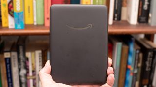 Amazon Kindle Colorsoft Signature edition e-reader showing graphic novels, cookbooks, and fiction, as well as settings