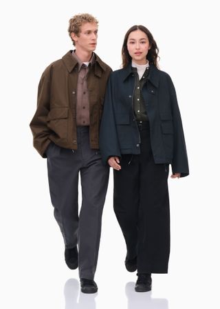 A man and woman wearing autumnal Uniqlo U jackets, smiling