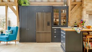 dark blue modern Shaker kitchen with built in stainless steel fridge freezer