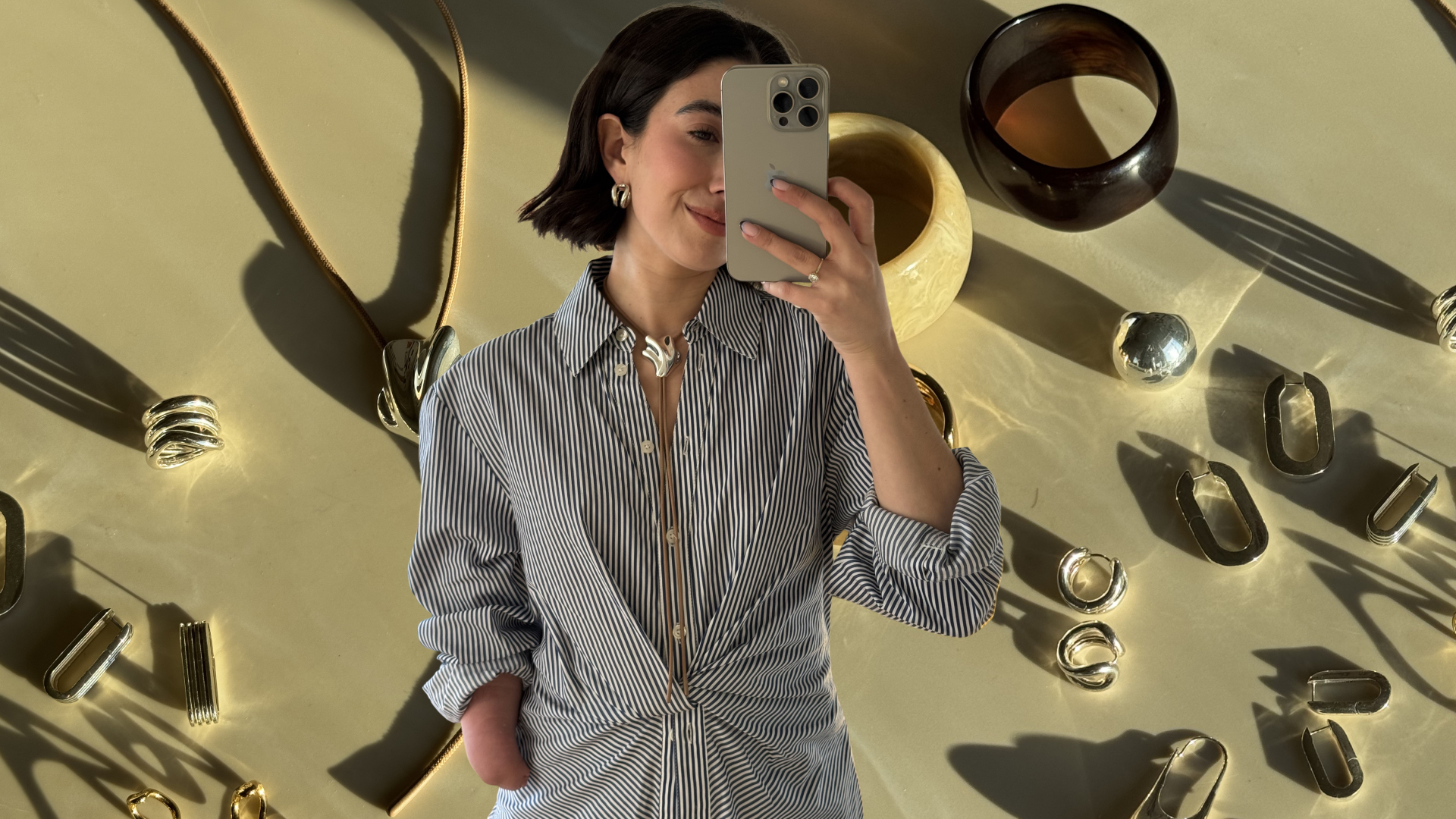 April Lockhart wearing her inclusive jewelry in front of a plain backdrop