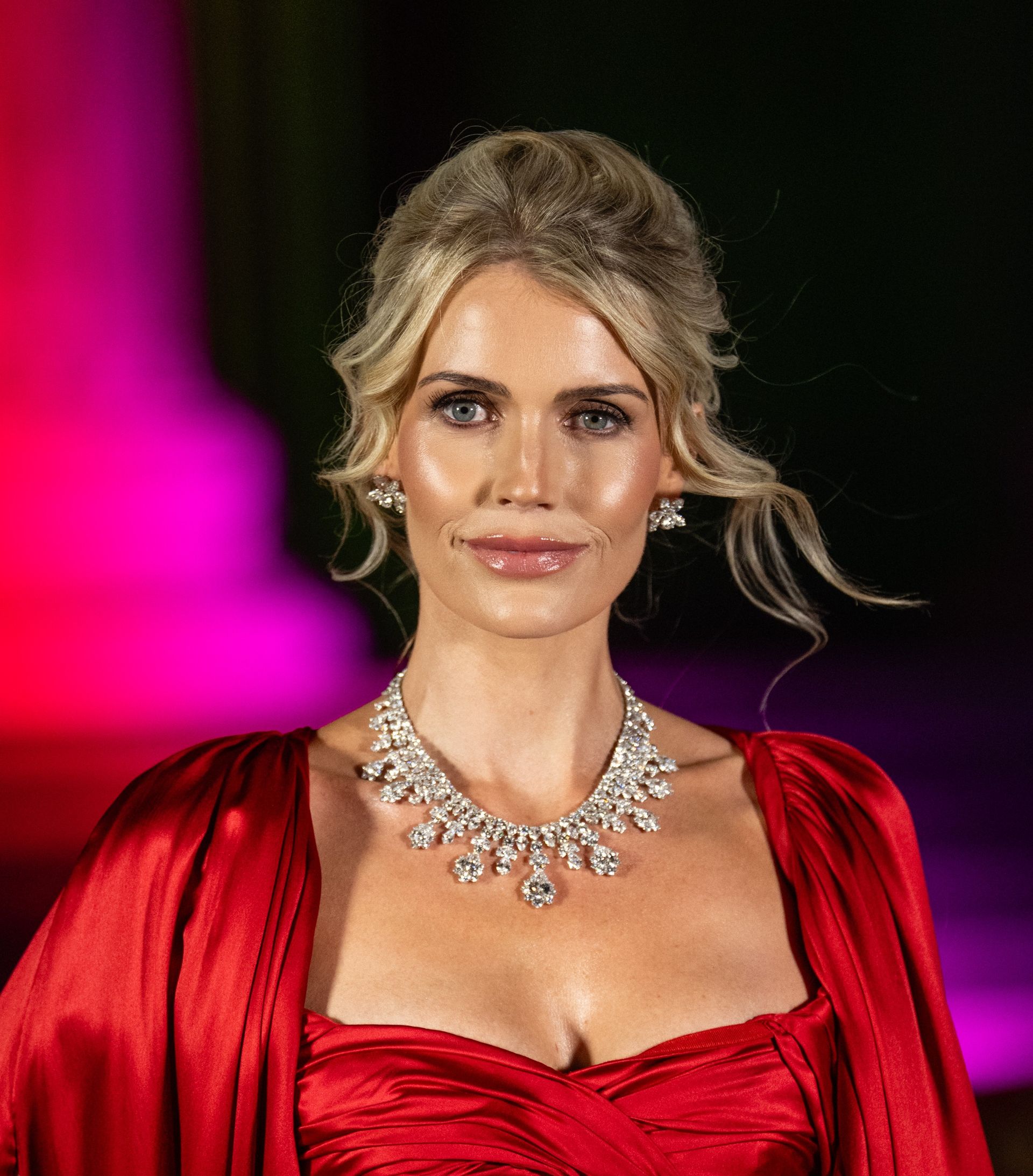 Lady Kitty Spencer wearing a red gown and diamond necklace