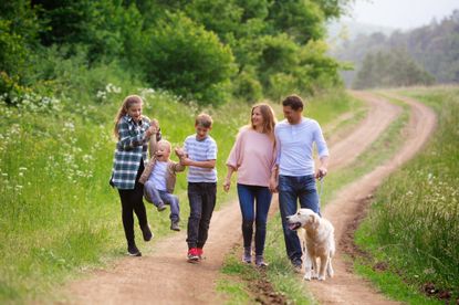 Family with kids and dog on a walk