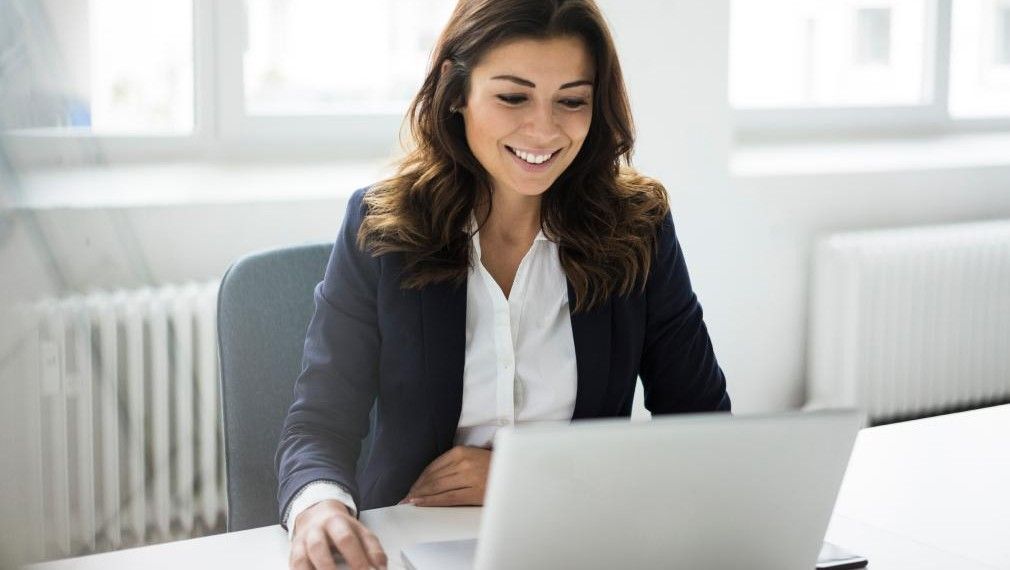 A woman working at a laptop