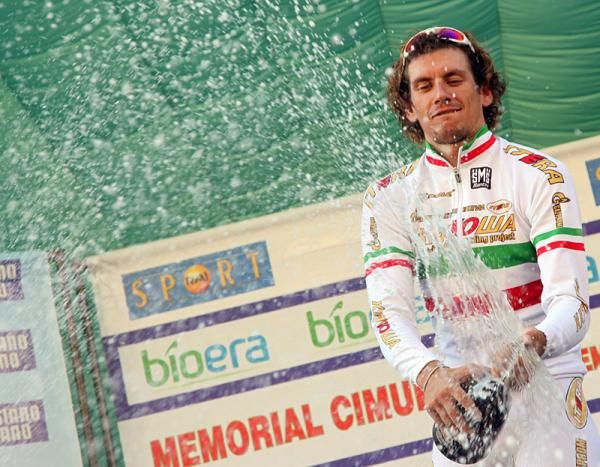 Pozzato uncorks the bubbly on the podium.
