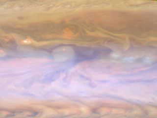 The dark hot spot in this false-color image from NASA's Cassini spacecraft is a window deep into Jupiter's atmosphere, a 'hot spot' discovered during a flyby in 2000. Image released March 14, 2013.