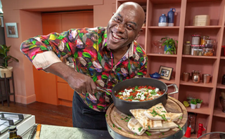 Ainsley's Food Flavours promo image featuring Ainsley stirring a bowl