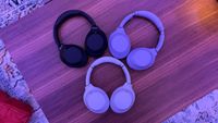 Three pairs of Sony WH-1000XM4C headphones arranged on a table