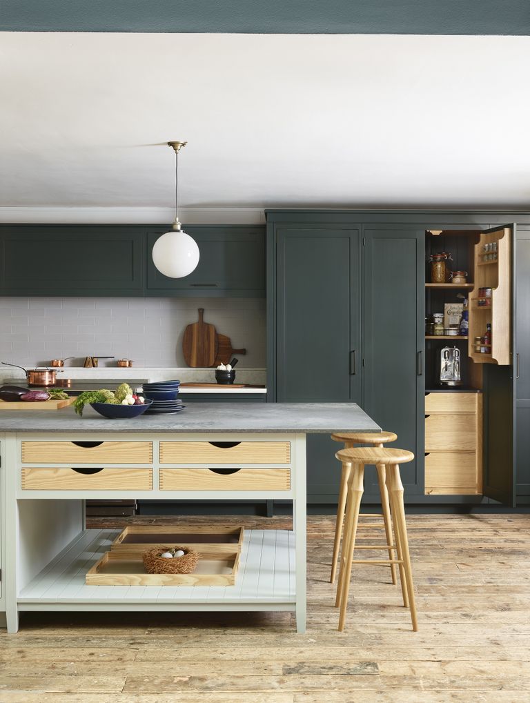 Kitchen with green cabinets and lighter island and wood floor