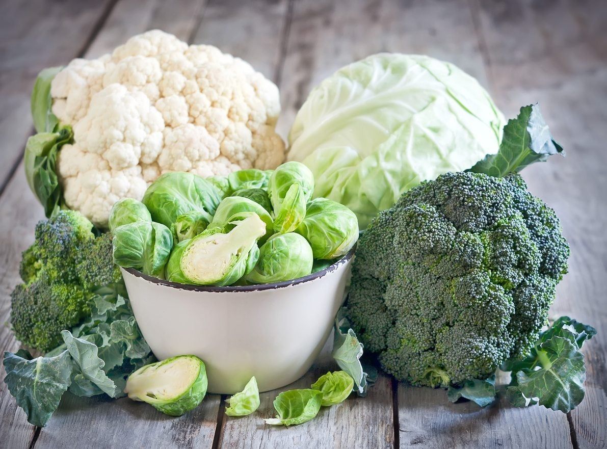 Bowl Full Of Brussel Sprouts Surrounded By Other Vegetables