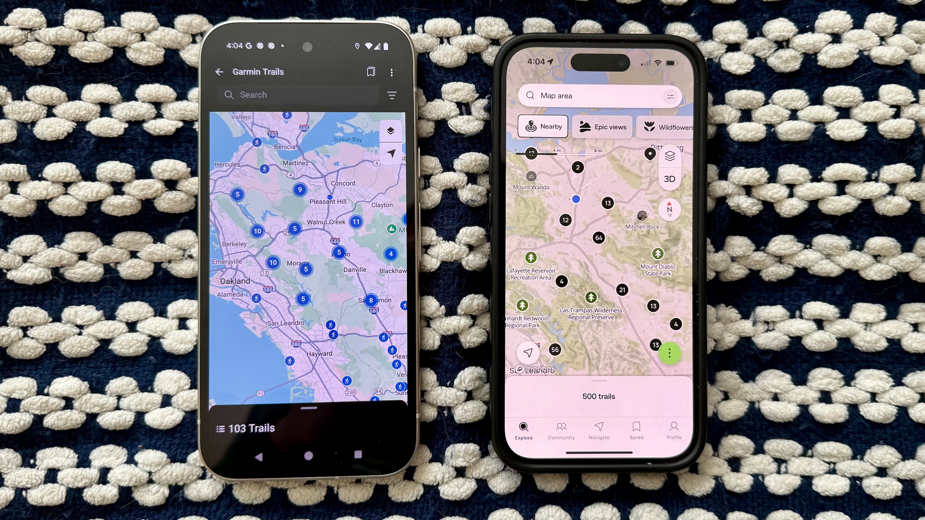Two side-by-side phones showing Garmin Connect Trails (left) and AllTrails (right), with Garmin showing 103 hikes in the California East Bay while AllTrails shows 500 hikes in a slightly smaller area.