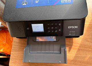 Epson printer printing a photo on a desk