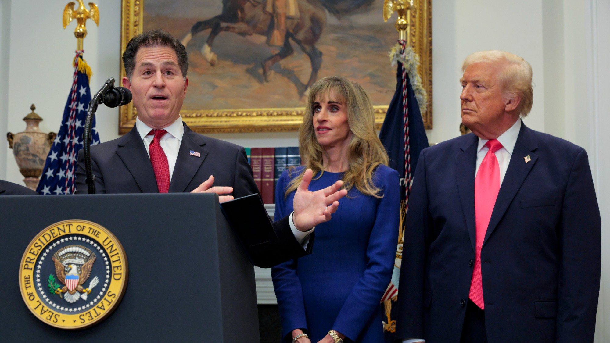 Michael Dell stands next to his wife Susan and President Donald Trump.