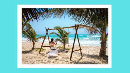 What is wanderlove? Pictured: woman on a swingset on the beach by herself in a white outfit