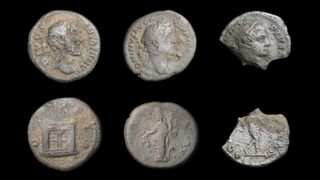 6 silver coins against a black background