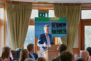 Dougherty addresses people at a Golf Foundation event