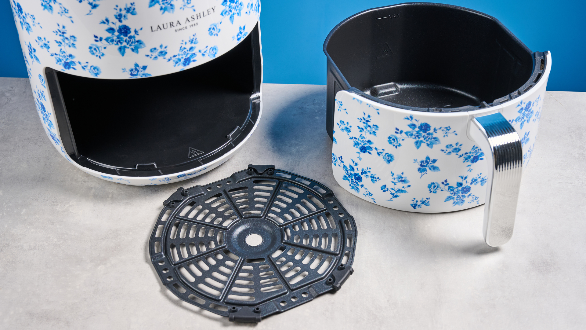 the Laura Ashley Air Fryer in blue and white floral print, showing the air fryer basket and black touchscreen on the top