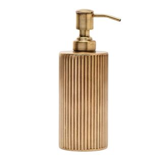 A brass soap dispenser