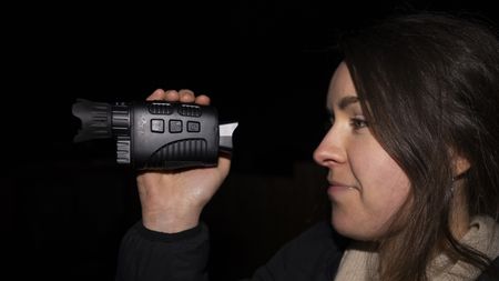 A female holding the Rexing B1 Basic night vision monocular