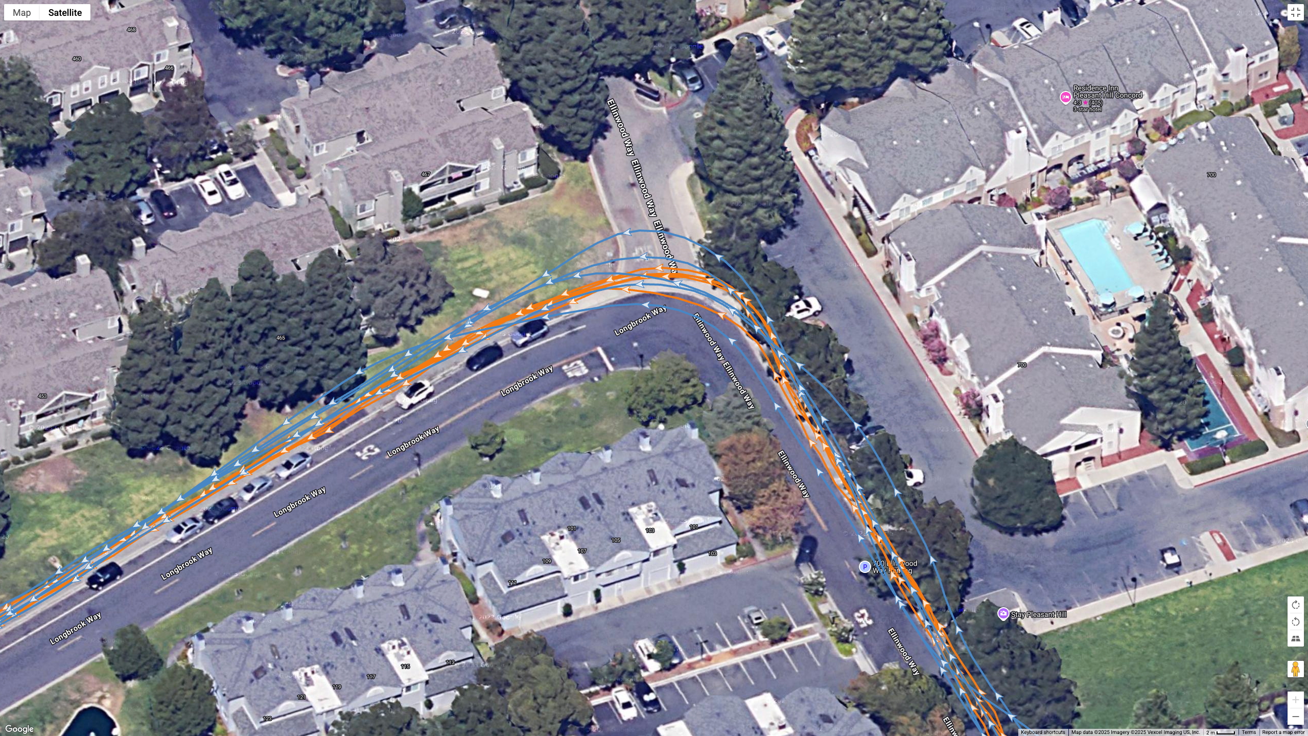 A Google Earth satellite map showing the GPS path of the Samsung Galaxy Watch 8 Classic (blue) and Garmin Forerunner 970 (orange) worn by the same runner.