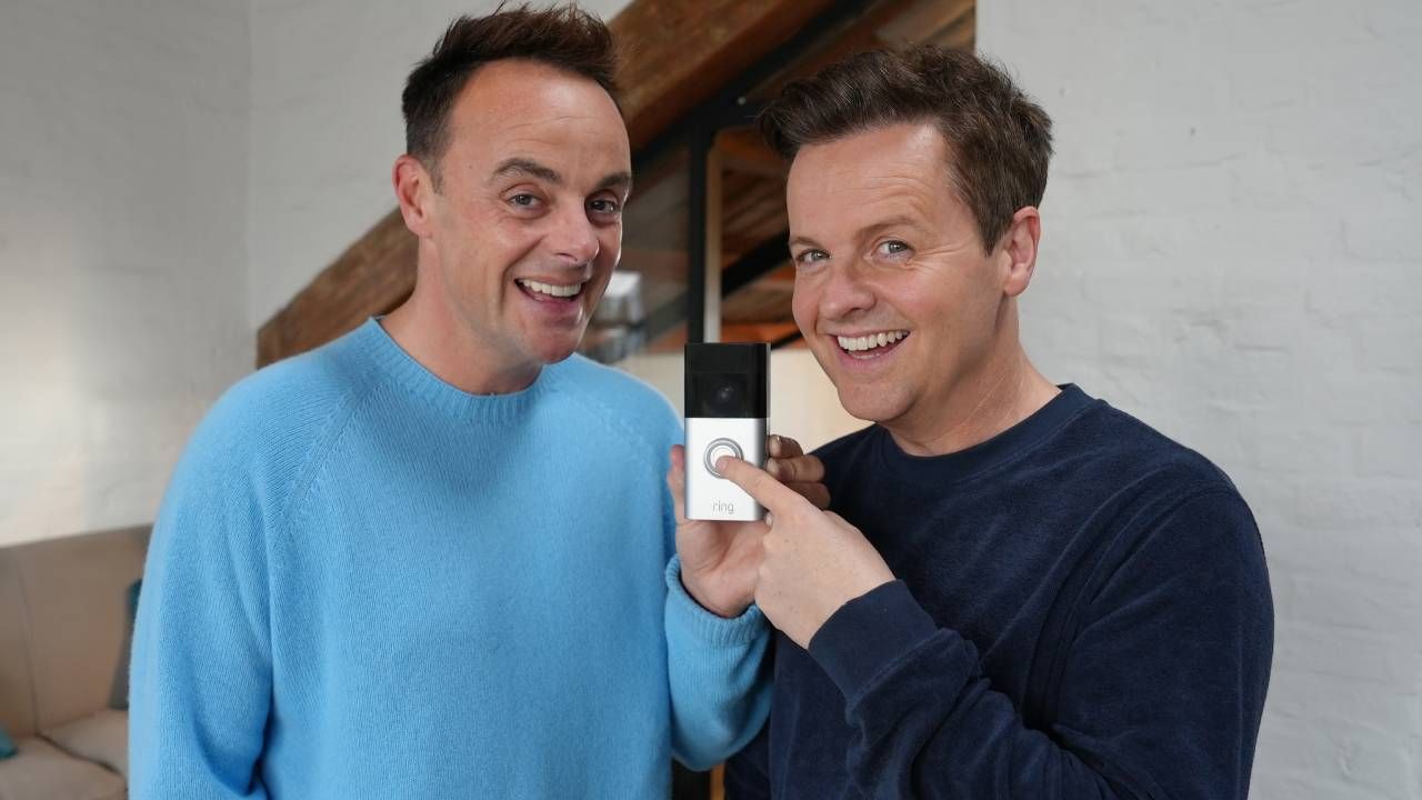 Ant and Dec smiling while holding a Ring video doorbell