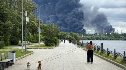 Woman in Moscow watches major oil refinery burn after Ukrainian drone strike
