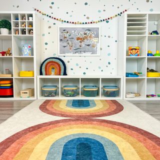 An IKEA playroom with KALLAX units and a rainbow rug