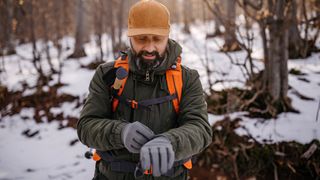 best hiking gloves: hiker adjusting gloves
