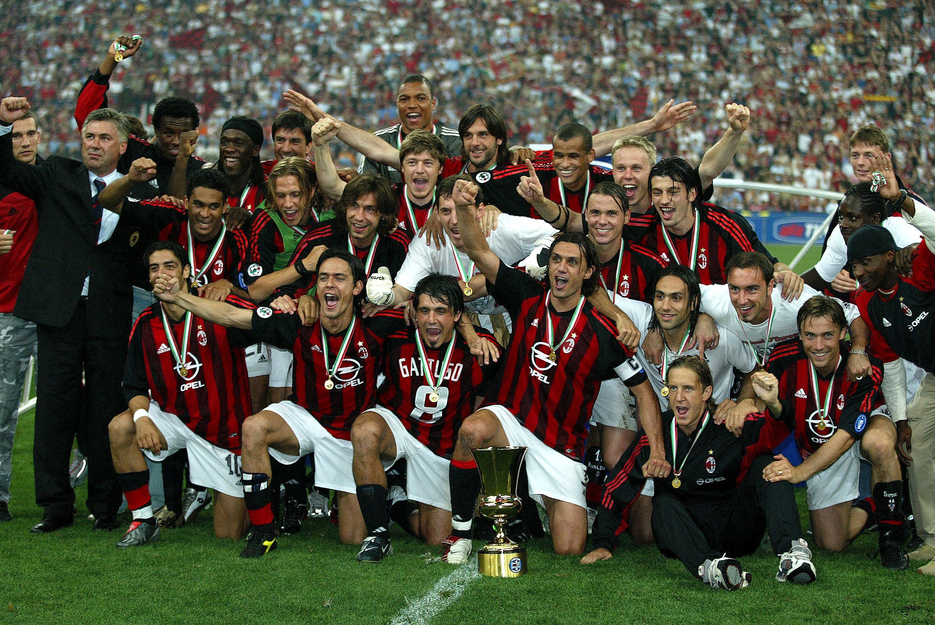 AC Milan players and coach Carlo Ancelotti celebrate the club's Coppa Italia final win over Roma in May 2003.