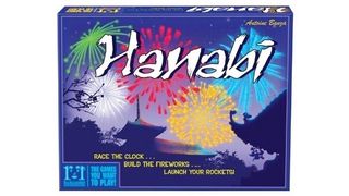 The box for board game Hanabi, showing fireworks going off over rooftops.