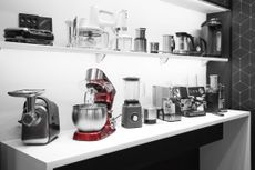 Coffee makers, mixers, meat grinders, blenders, coffee machines, toasters and kettles on a shelf