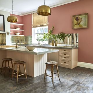 Pink kitchen with wooden island