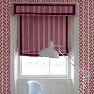 home office with pink blinds and wallpaper
