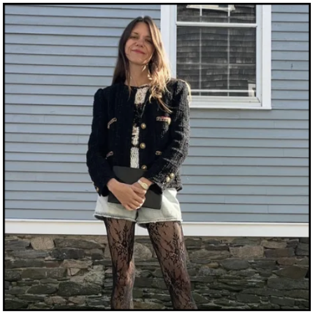 Julia Gall wearing a black cardigan and shorts