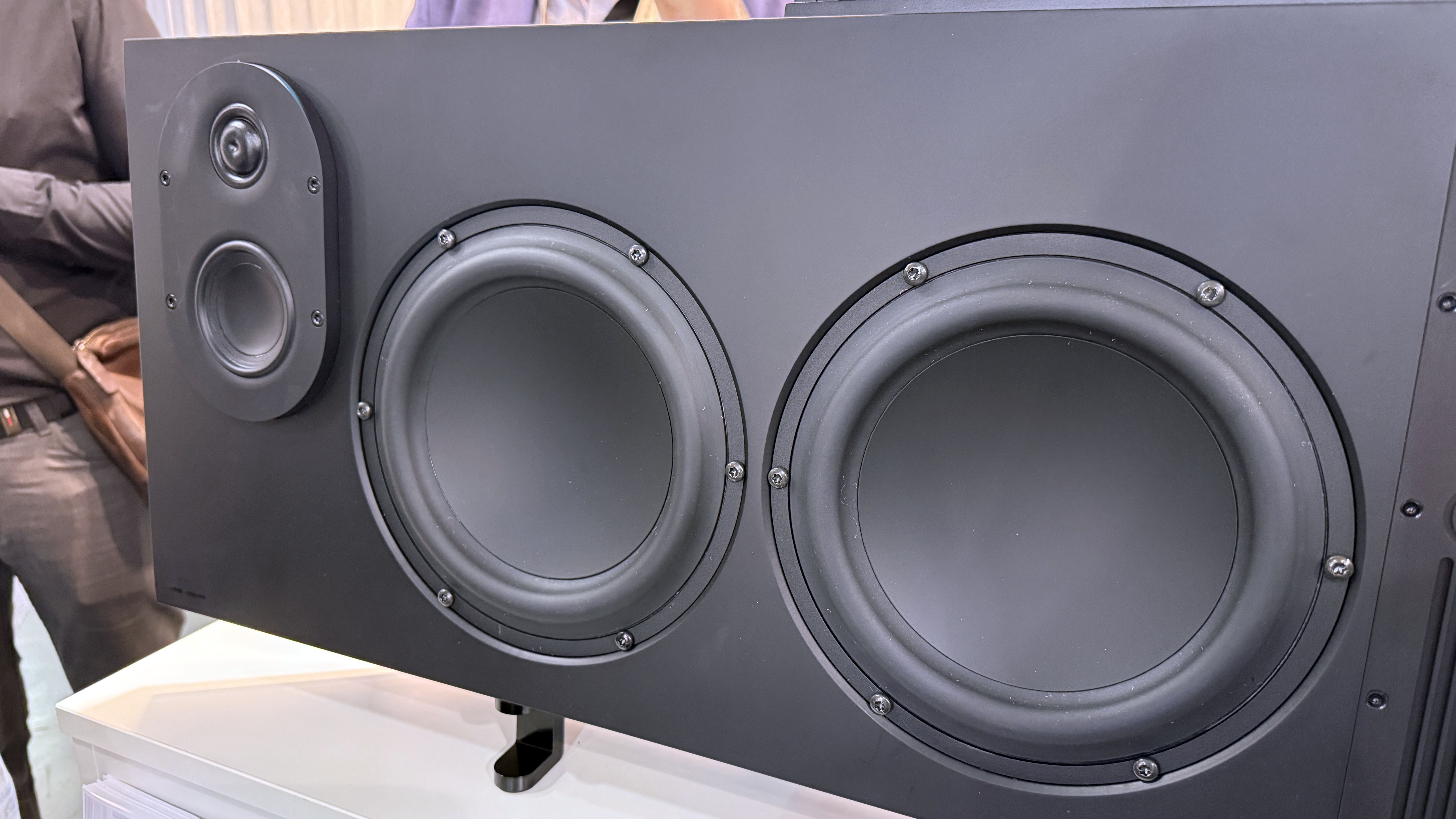 A close-up of the Canvas L soundbar's speakers on one side of it, showing the tweeter and mid combination, then two larger woofers