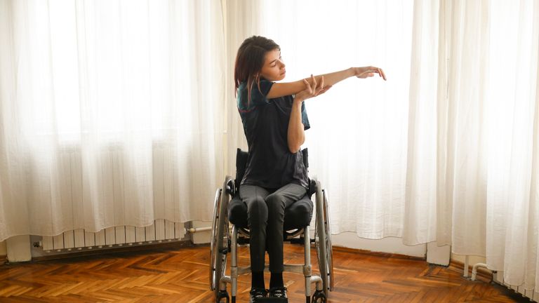 Stretching person in wheelchair
